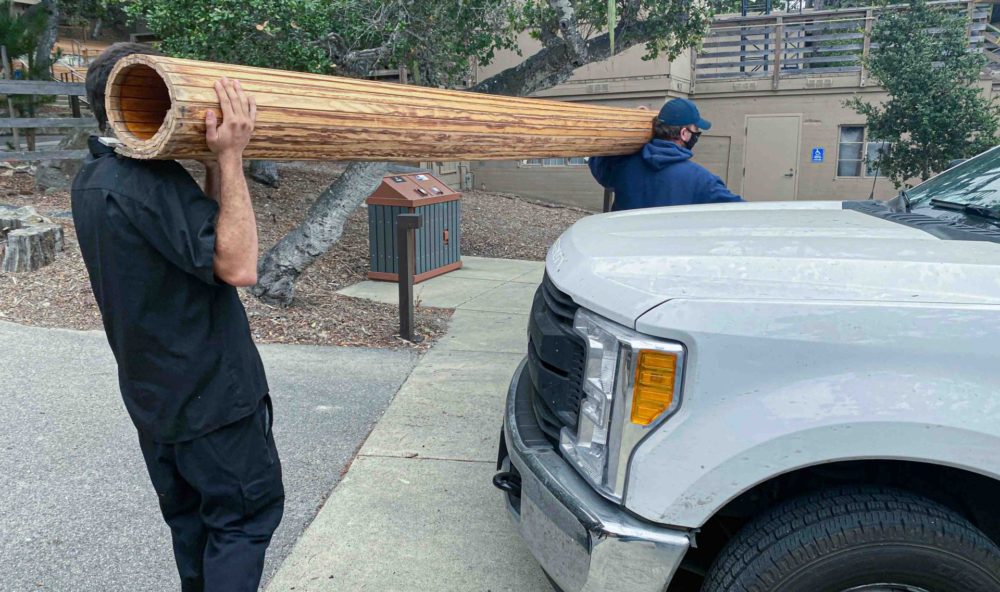 Workers taking away old theater door