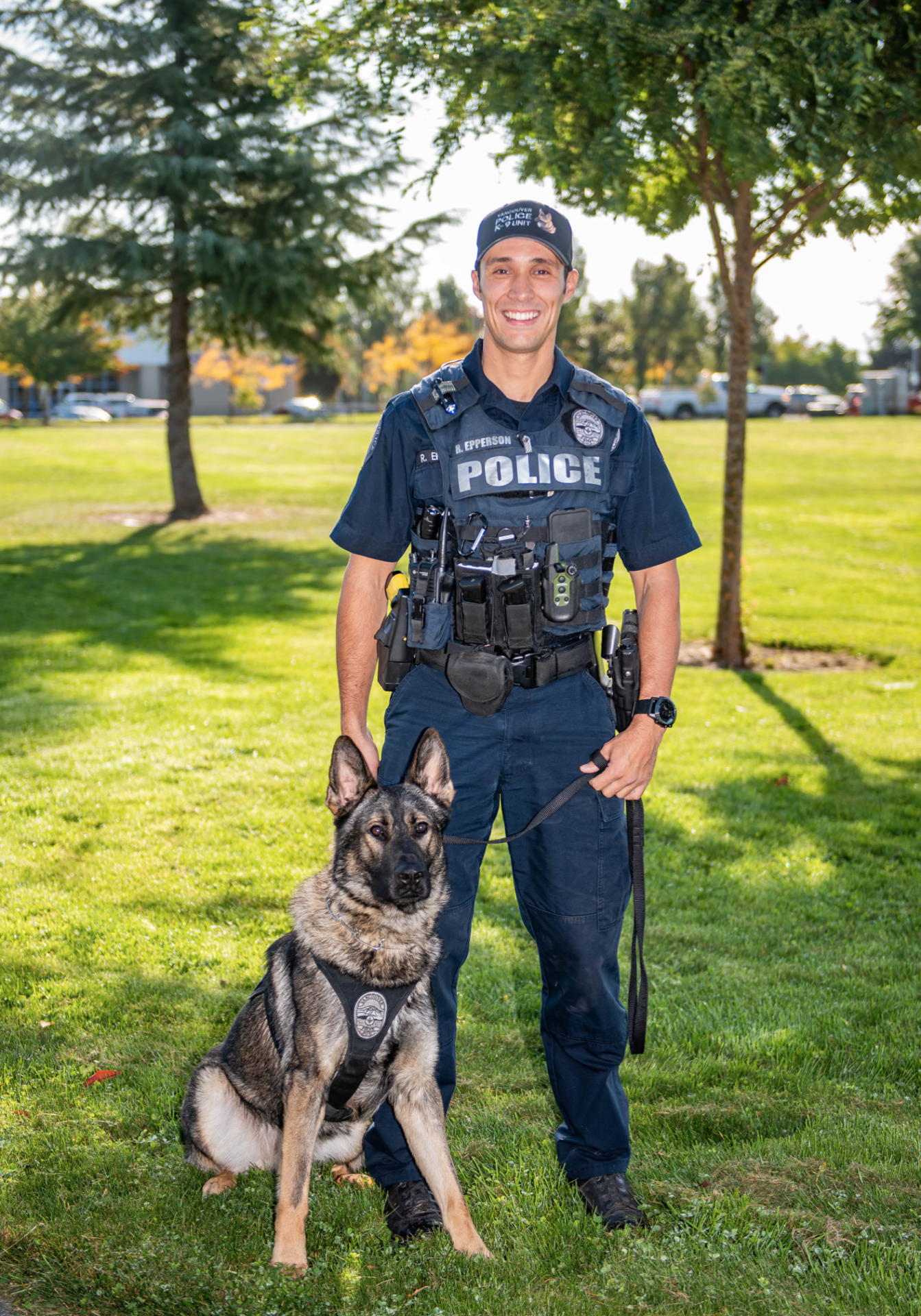 Officer with Shepard on Grass